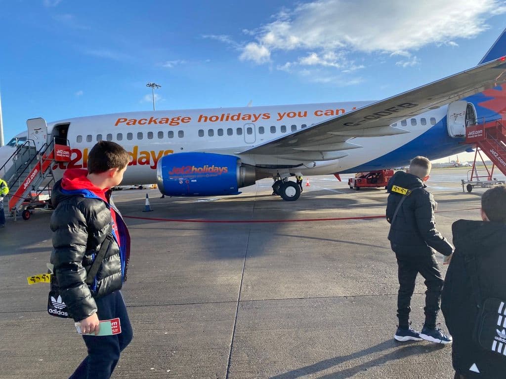 children boarding a JET2 holidays airplane on a sunny day to Paris.